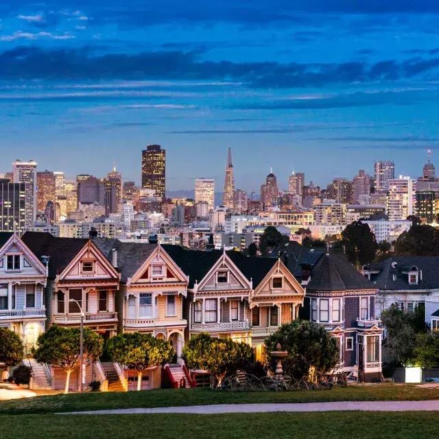 유명한 알라모 광장의 페인티드 레이디스(Painted Ladies of Alamo Square)는 황혼 무렵 贝博体彩app 스카이라인 앞에 그려져 있습니다.